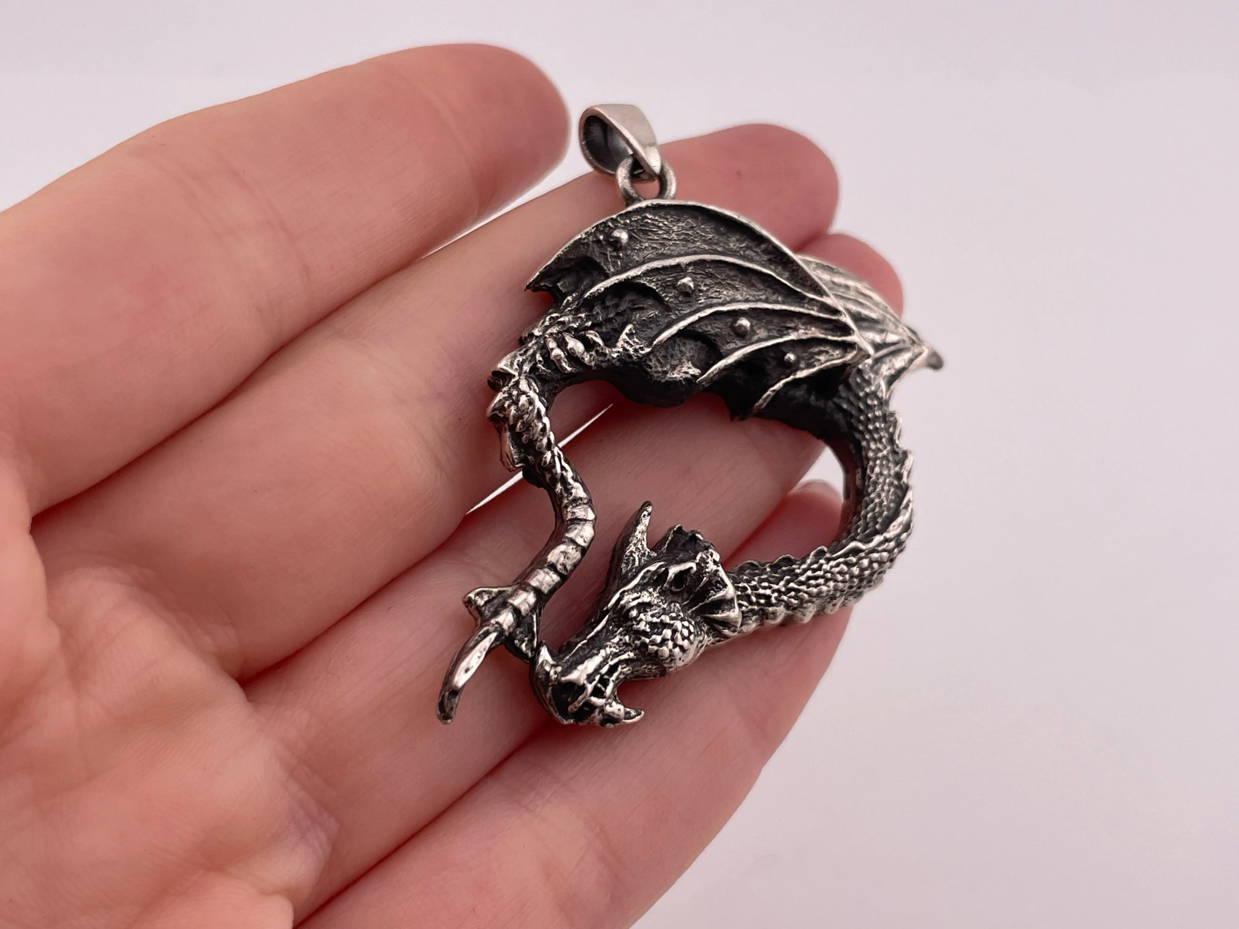 sterling silver bending dragon pendant