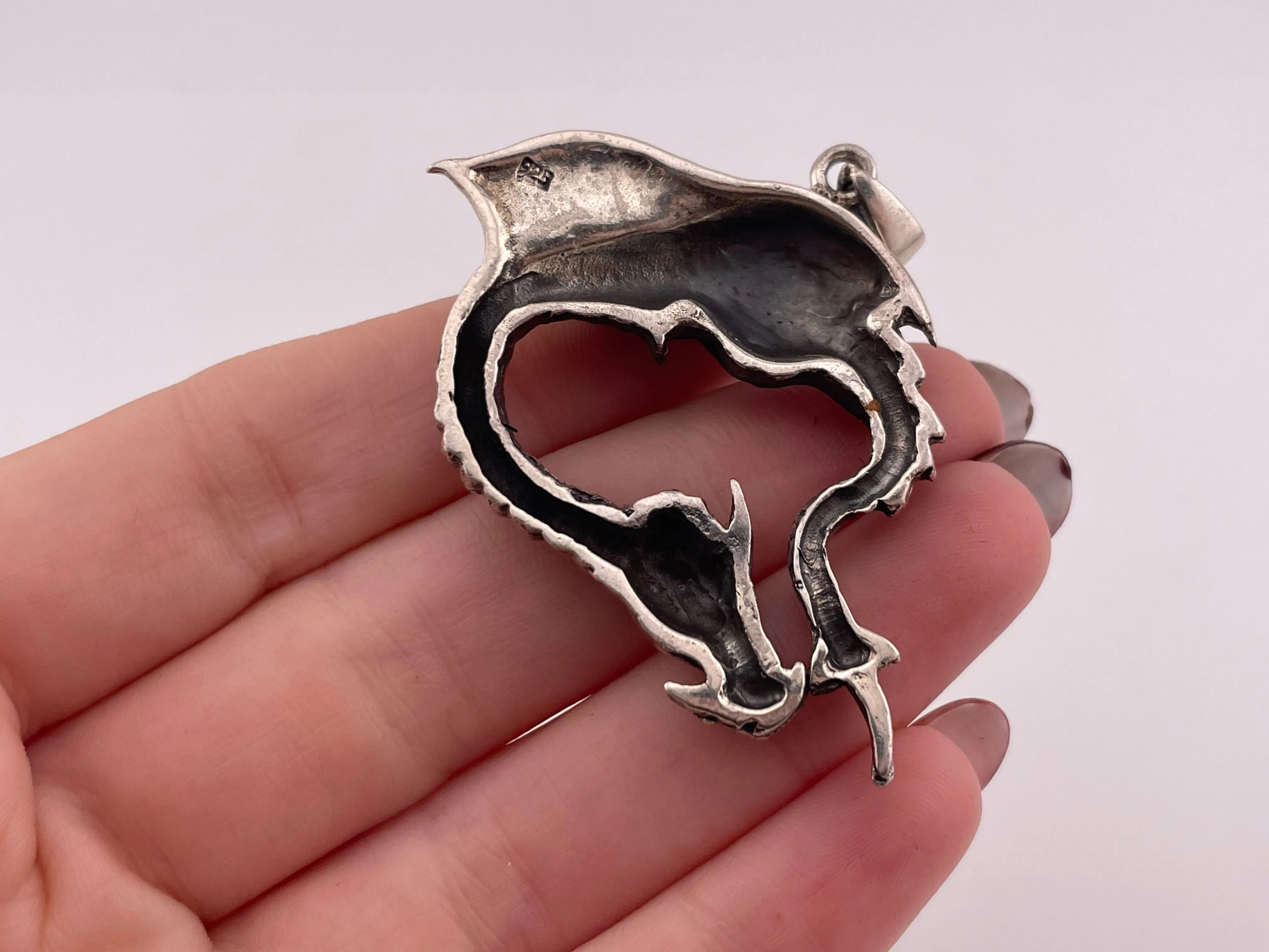 sterling silver bending dragon pendant